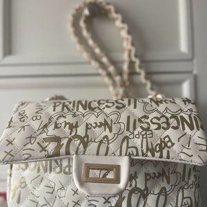small white purse with gold accents